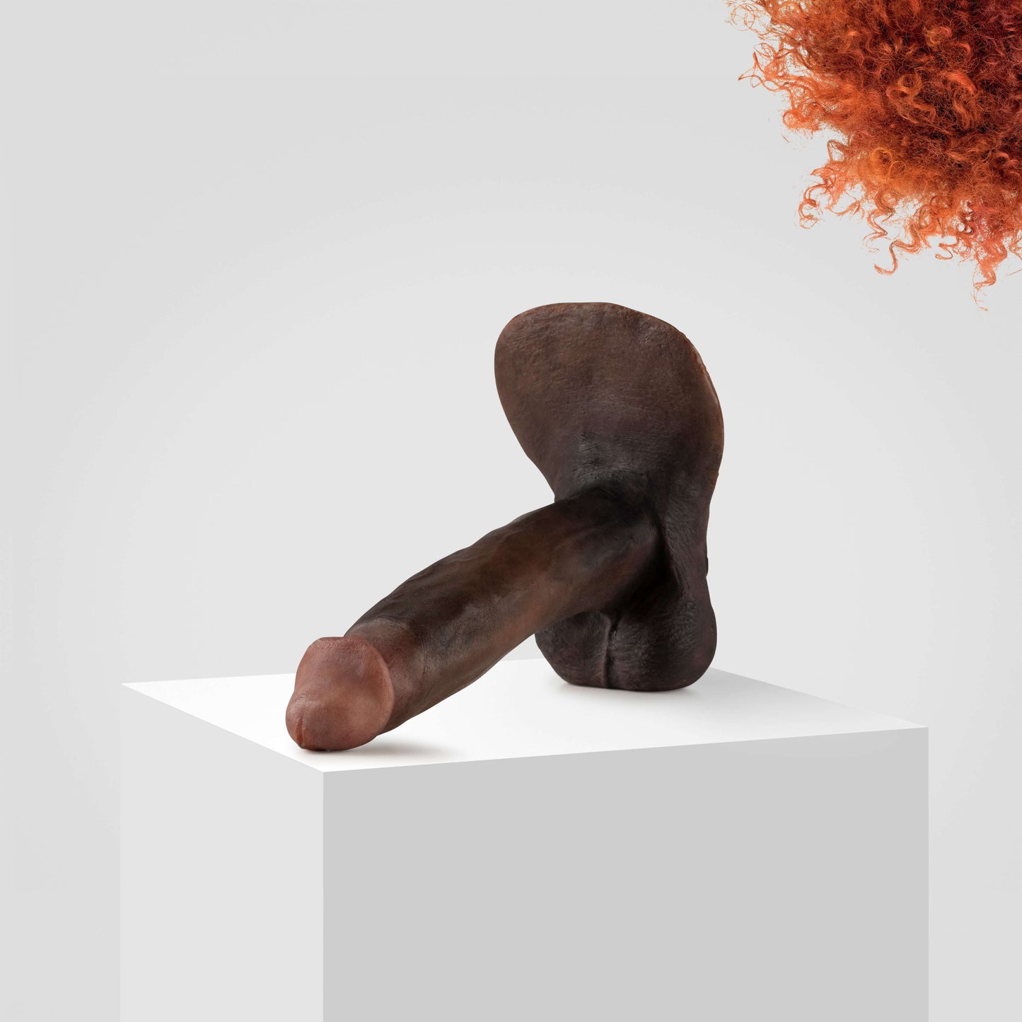 Ultra-realistic Emisil FTM packer model in dark skin tone displayed on white pedestal