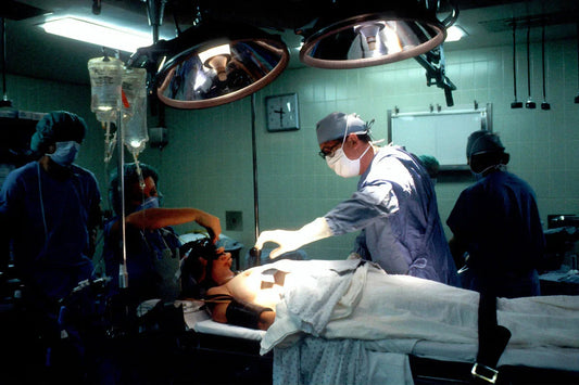 Surgeons performing surgery in a well-lit operating room with medical equipment